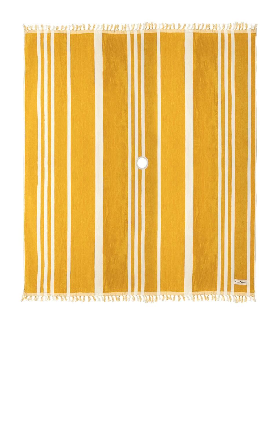 Their striped blanket is 100% cotton, hand-loomed in Pakistan, and comes with leather carrying straps so you can roll it up and easily transport it.